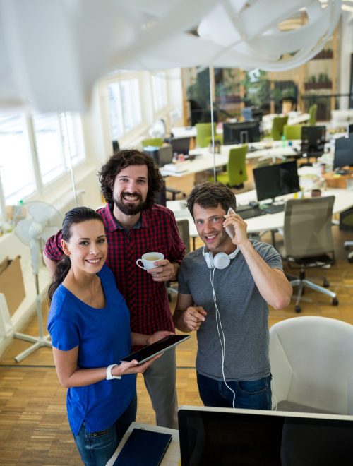 Group of graphics designers using digital tablet in office