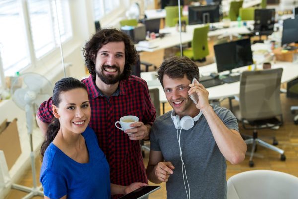 Group of graphics designers using digital tablet in office